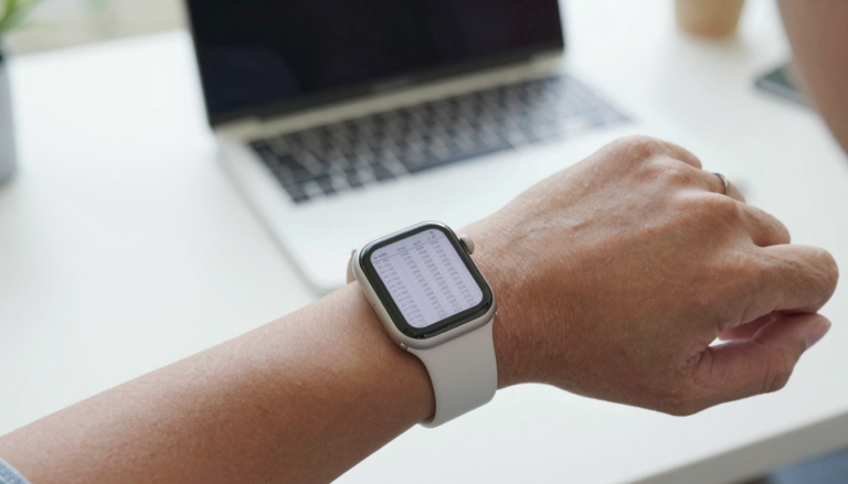 Apple Watch on a wrist displaying an Excel spreadsheet in a document viewer app