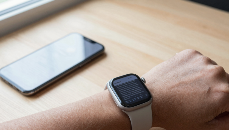 Apple Watch on a wrist syncing a PDF document from an iPhone for offline reading